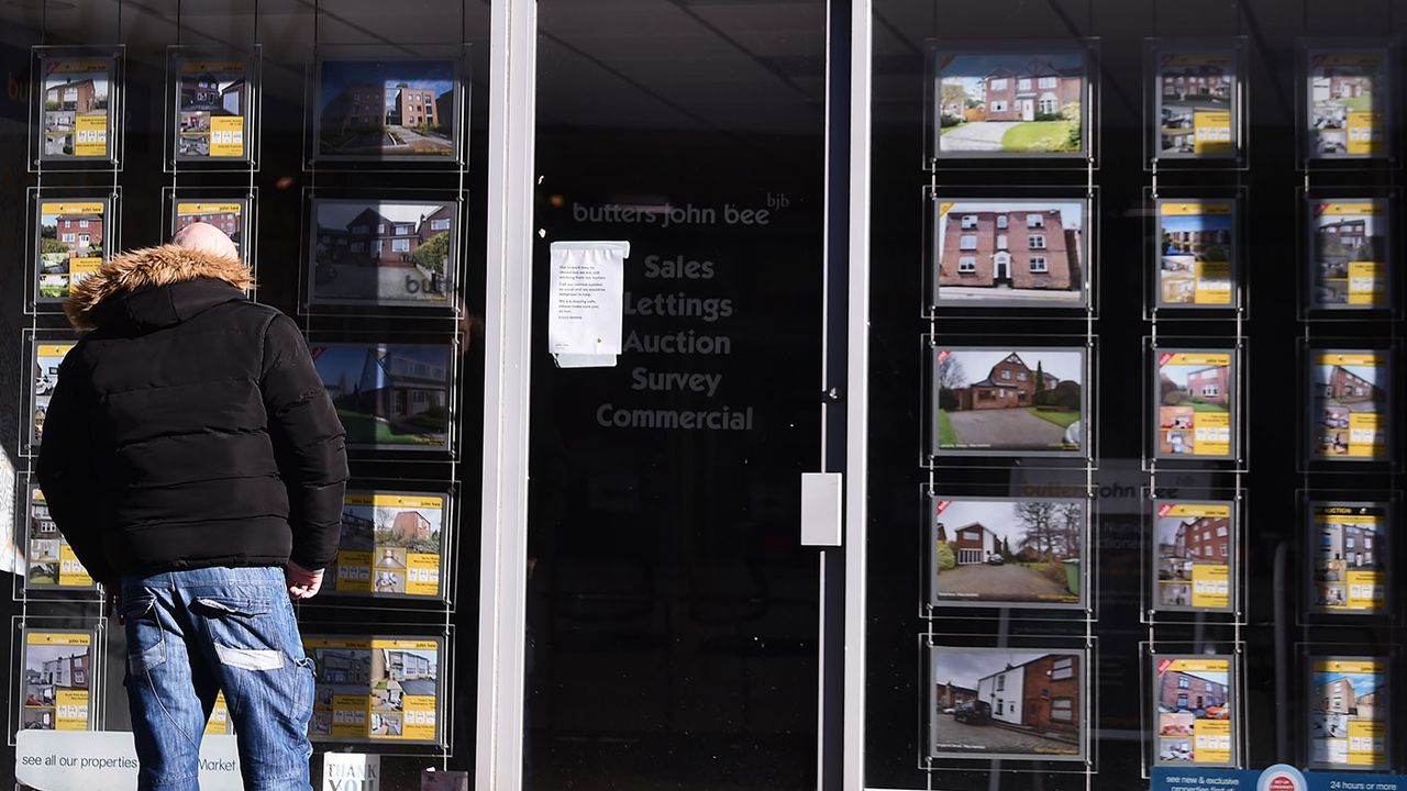 Man looking in an estate agent&amp;#039;s window