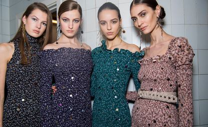 Models wear a range of dresses, in high-neck, bardot and cold shoulder designs. Each have a floral pattern, in navy, purple, blue and pink