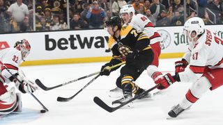 Charlie McAvoy #73 of the Boston Bruins skates against Antti Raanta #32, Martin Necas #88 and Andrei Svchnikov #37 of the Carolina Hurricanes in Game Six of the First Round of the 2022 Stanley Cup Playoffs at the TD Garden on May 12, 2022 in Boston, Massachusetts.