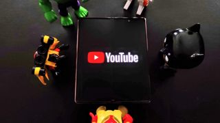 YouTube on Galaxy Z Fold 2 with toys around it