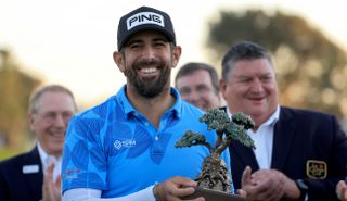 Matthieu Pavon holds the Farmers Insurance Open trophy