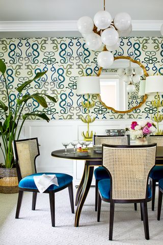 dining room with wallpaper and blue velvet dining chairs