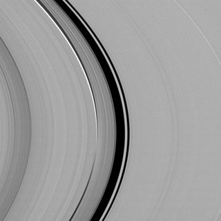 A dynamical interplay between Saturn's largest moon, Titan, and its rings is captured in this view from NASA's Cassini spacecraft taken on Sept. 20, 2009 and released Dec. 23, 2013.