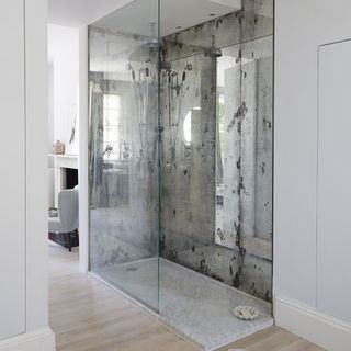 bathroom with shower and Carrera marble