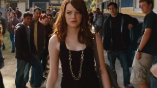 Olive in a black tank top being looked at on campus in a scene from Easy A 2010.