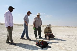 Researchers at the so-called Mleisa 1 trackway site in the Arabian Desert where the 7-million-year-old footprints from a four-tusked elephant ancestor were found. From left to right, Ahmed Abdalla Al-Haj (ADTCA), and co-authors, Brian Kraatz, Mark Beech,