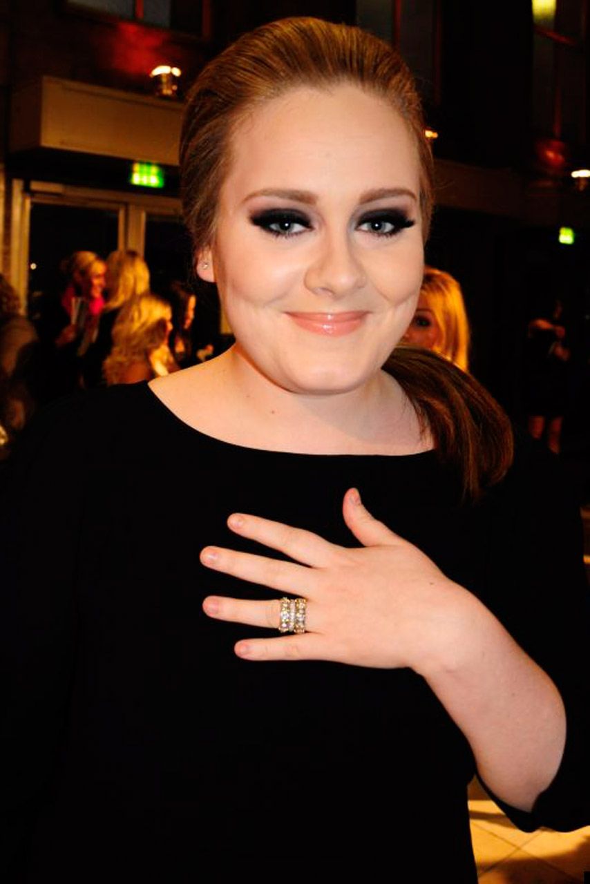 Adele shows off a diamond band on her wedding finger