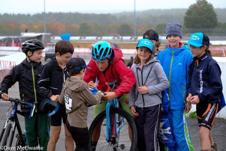 USA Champion Katie Compton (Trek Panache) takes time out of her warmup to sign autographs for kids at the race