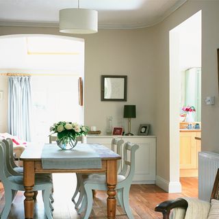 white dining room with table and wooden floor
