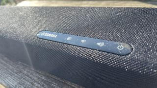 A closeup of the controls on top of the Yamaha SR-C30A soundbar