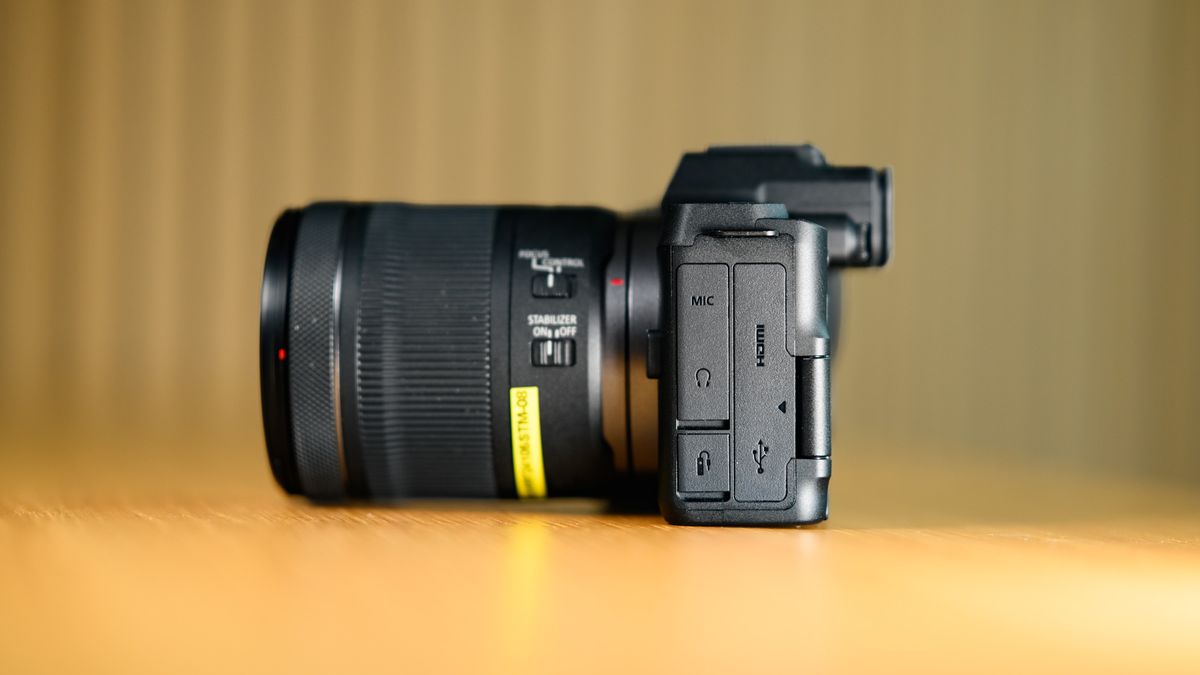 Side profile of the Canon EOS R8 Mark II, on a wooden table