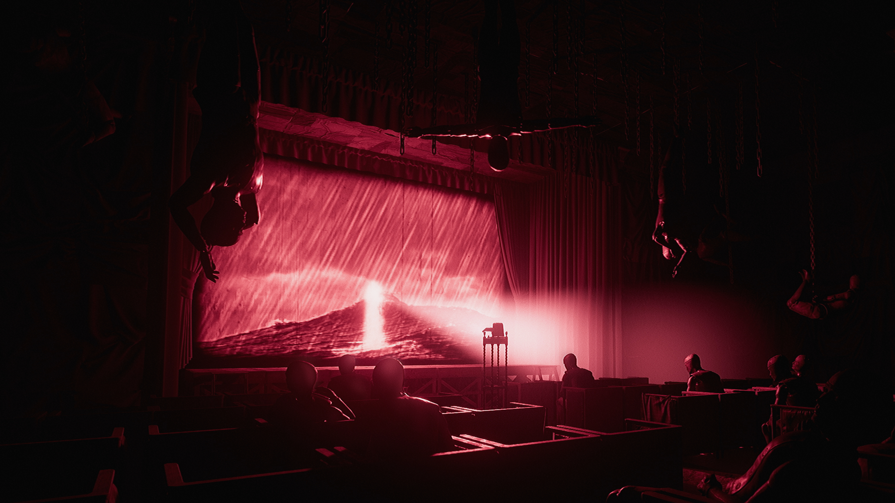 a theatre room with a few people in the audience