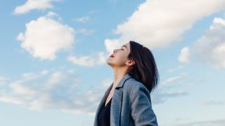 Breathing for relaxation: image shows woman breathing fresh air