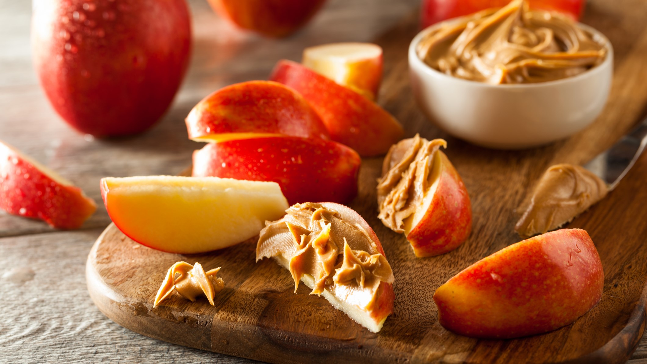 A photo of some apple with peanut butter - a healthy snack idea