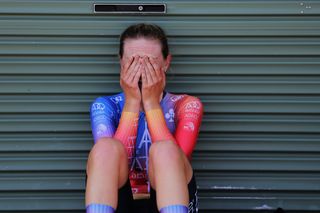 Lizzie Holden covers her face after winning the time trial