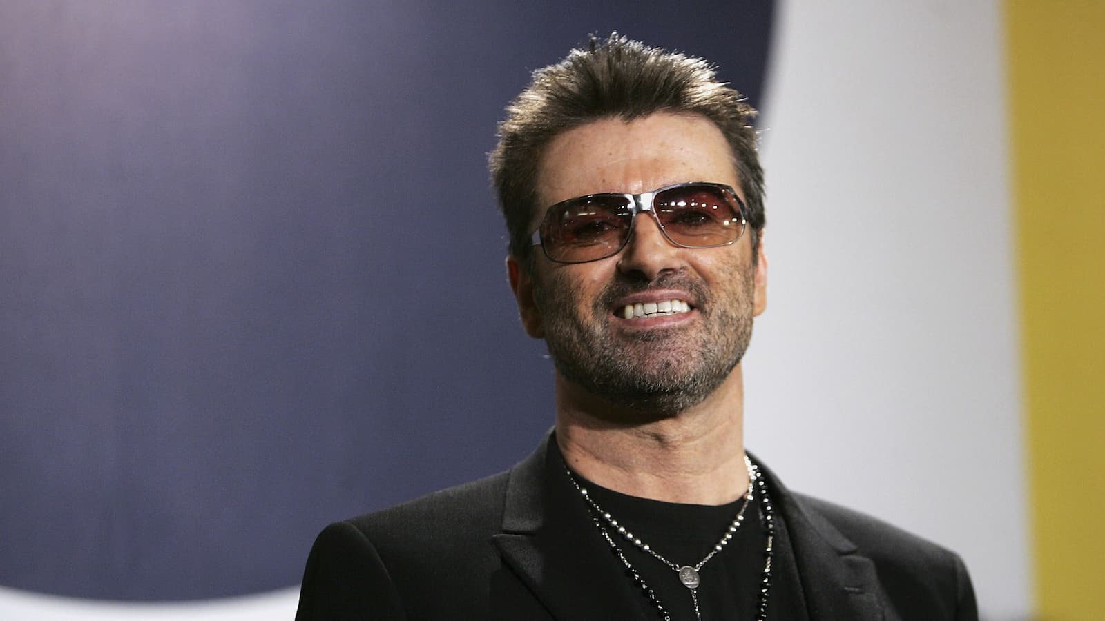 George Michael at a film premiere smiling