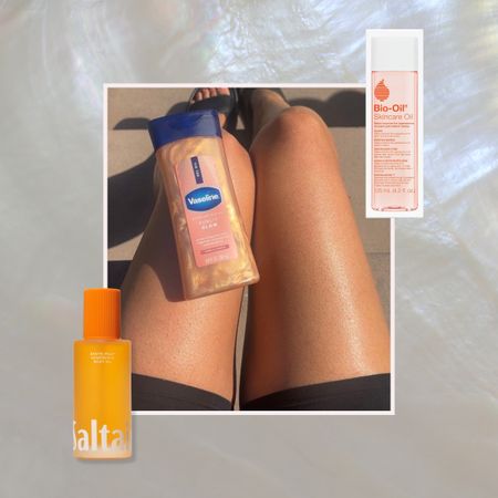 two bottles of drugstore body oils on a silver background next to a woman's legs with a bottle Vaseline body oil on top in the sunshine