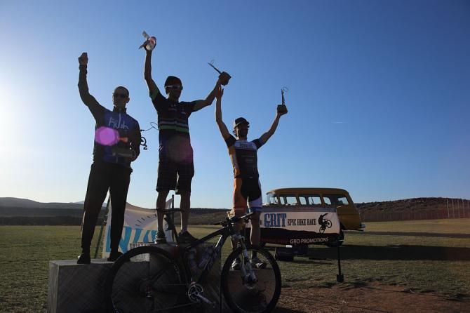 Drew Edsall atop the men's podium at the True Grit 100