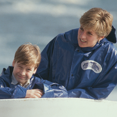 Prince William and Princess Diana both wear blue rain coats and have similar dusty blond hair