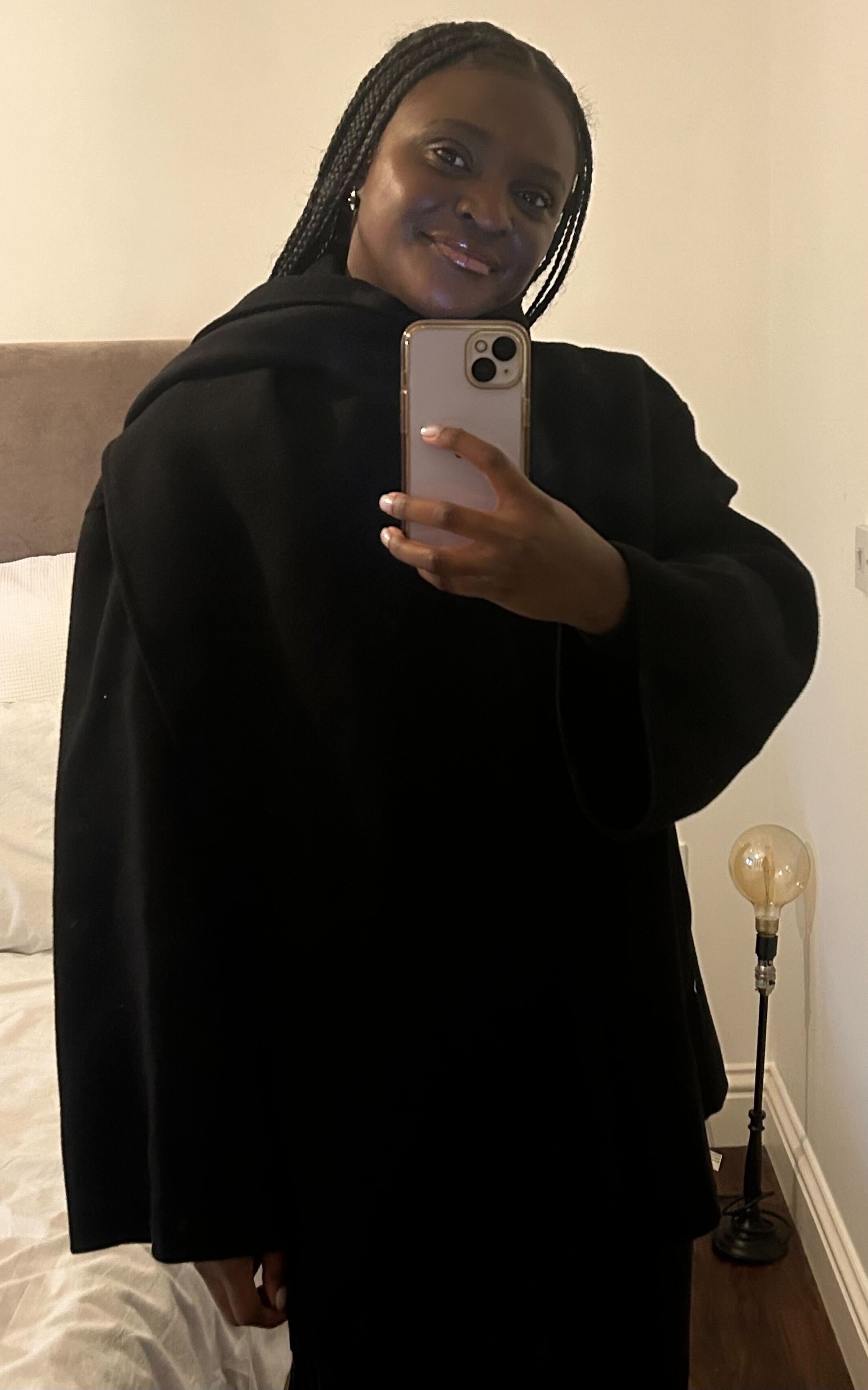Woman wears black scarf coat