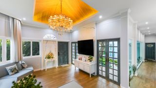 A Crystal chandelier hangs over a living room