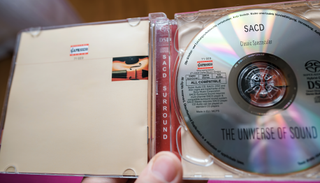 A classical music SACD in its case, held in a hand