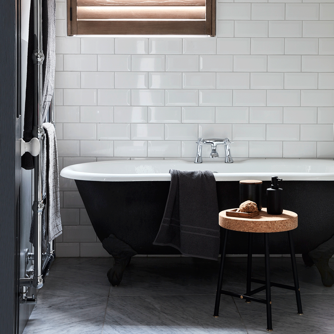 bathroom with white tiles wall bathtub and table