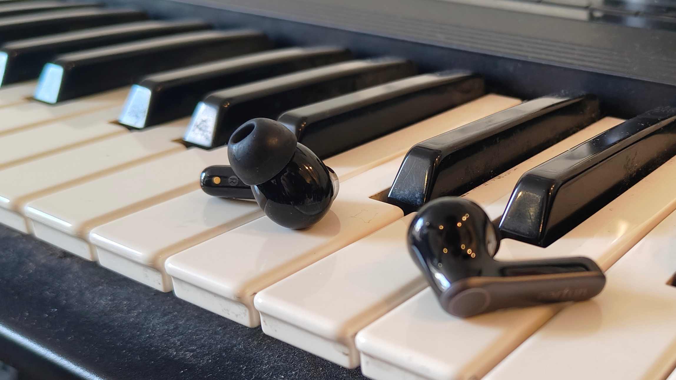 The Earfun Air Pro 4 Plus on top of a keyboard.