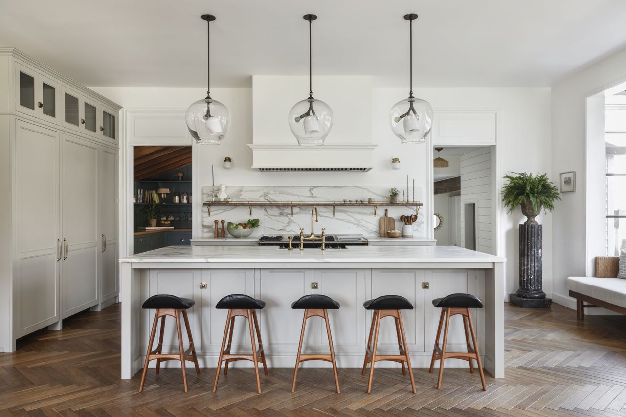 A white kitchen with transparent globe lights