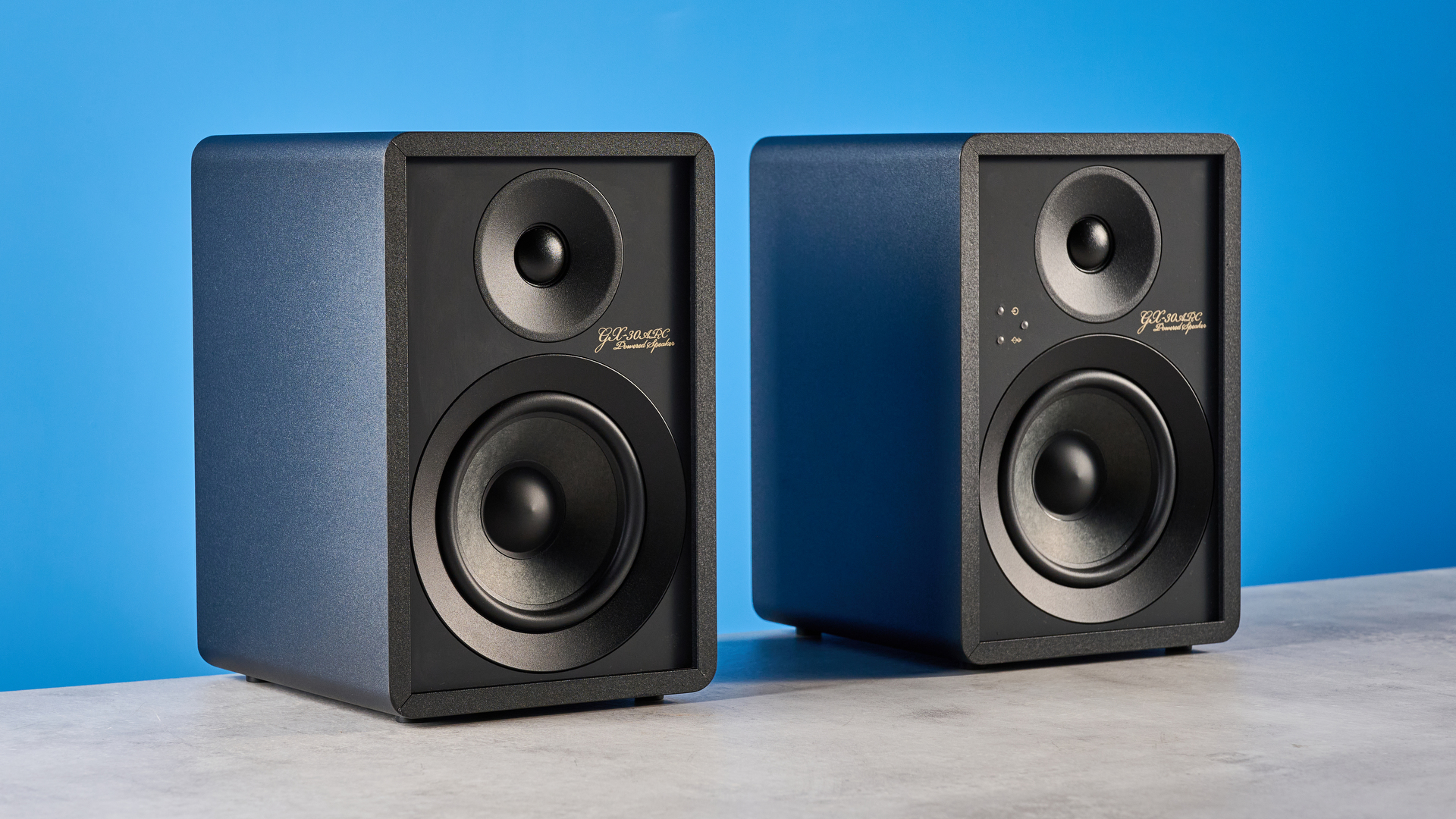 Onkyo GX-30ARC bookshelf speakers photographed on a blue background
