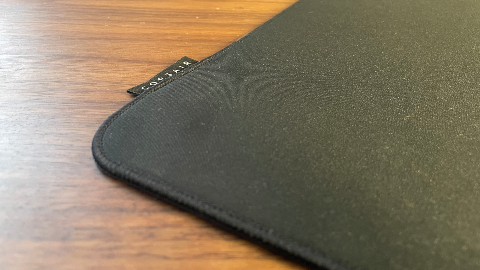 A Corsair MM Pro mouse pad on a desk.