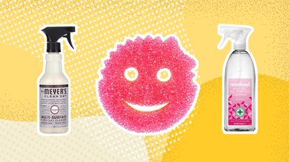 A selection of cleaning supplies including Mrs. Meyers cleaning spray, Scrub Daddy sponge and Method Anti-bacterial rhubarb spray on yellow background
