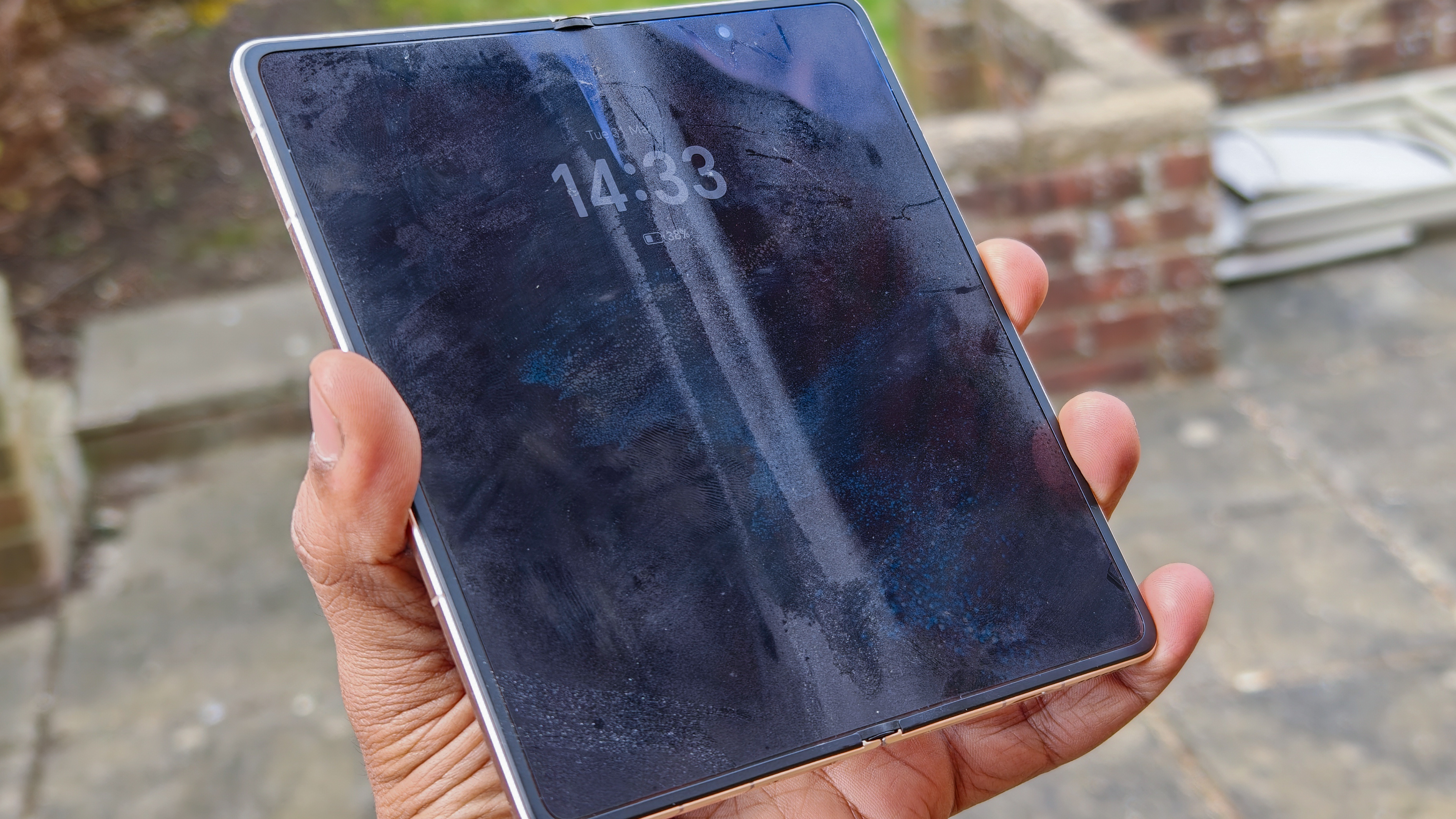 The Honor Magic V6 in gold after being put through a washing machine, complete with scratches and blemishes but fully working. 