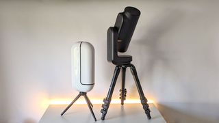 The Vaonis Vespera 2 and the Unistellar Odyssey Pro side-by-side on a white table and background, demonstrating their size difference.