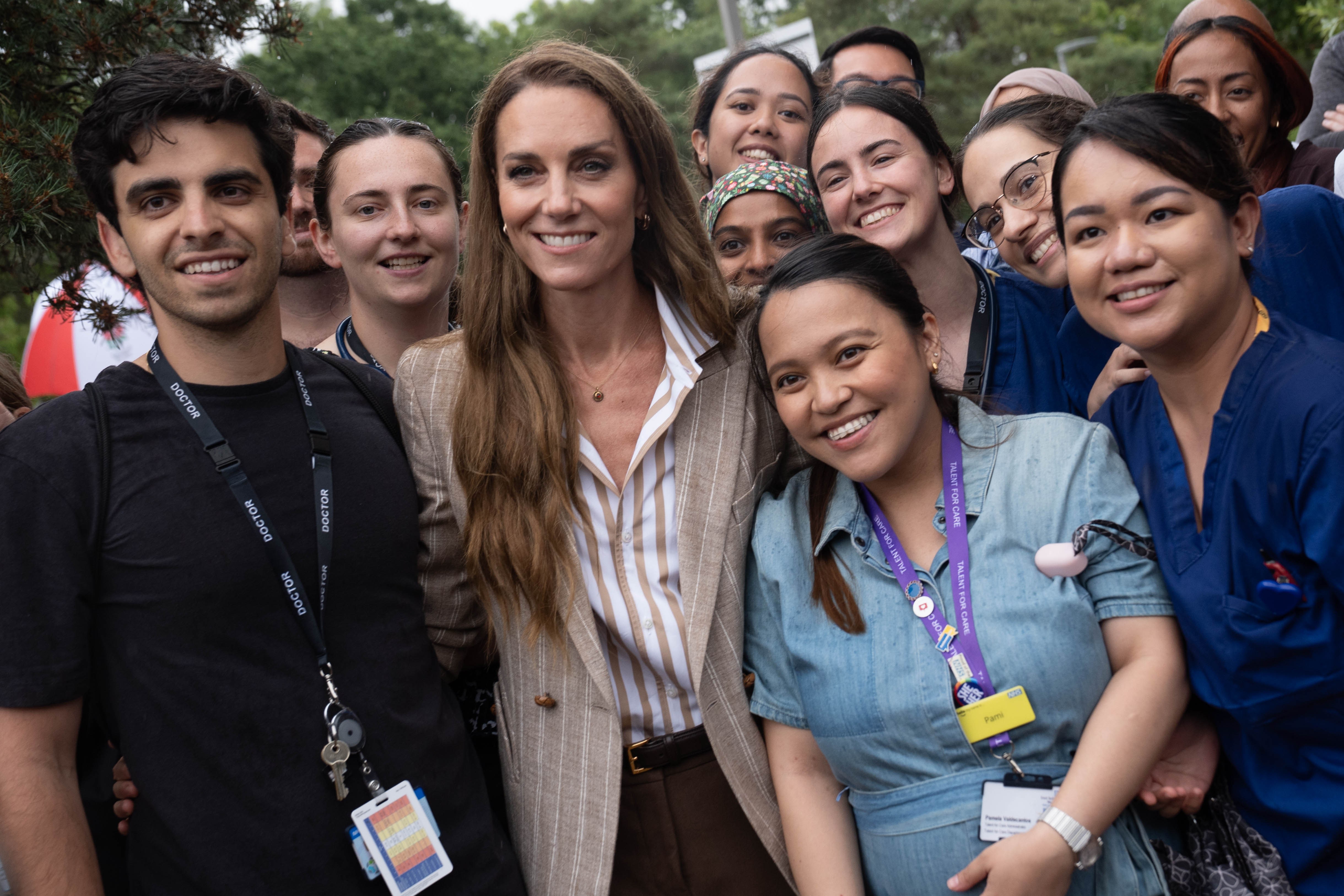 Kate Middleton smiles alongside nurses and staff during a visit to Colchester Hospital