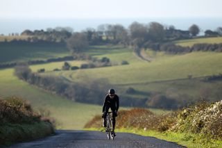 Image shows a cyclist riding in the winter.
