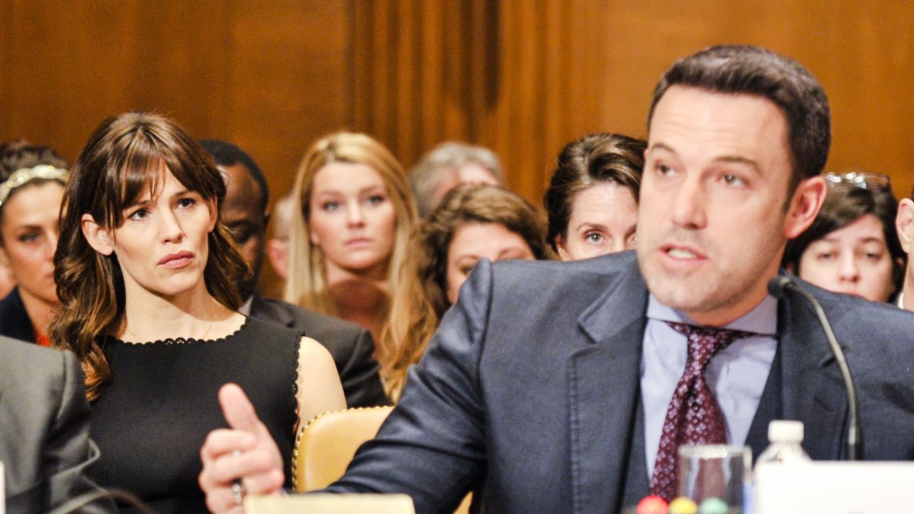 Woman in the crowd looks on at proceedings in a court