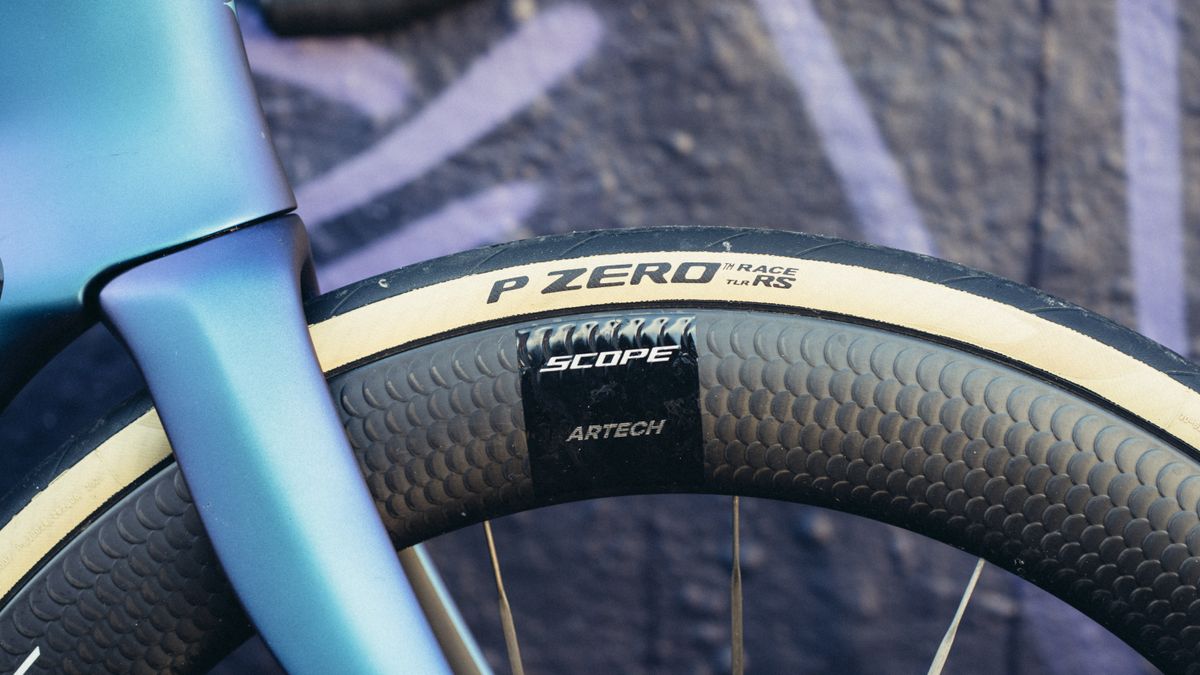 A close up of a deep black bicycle rim with a Pirelli P Zero Race TLR RS tyre mounted to it