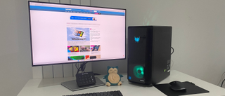 Acer Predator Orion 3000 desktop gaming PC on a desk with RGB lighting turned on.