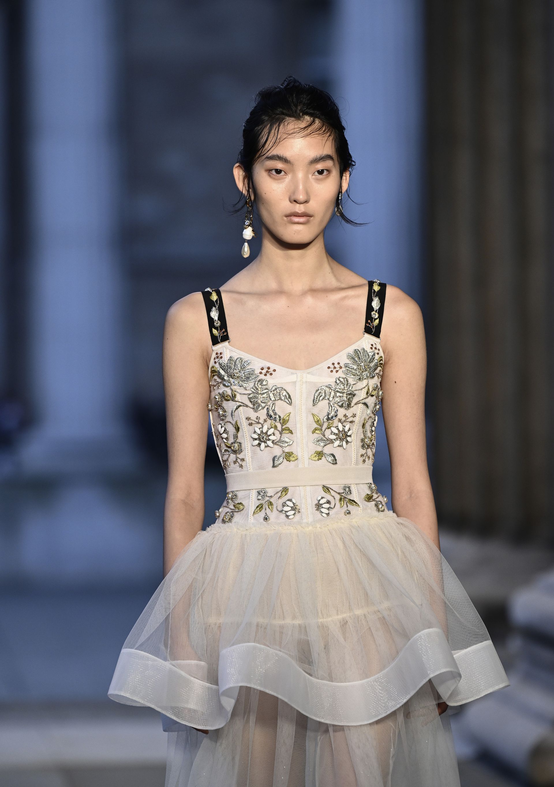 Model wears peplum top from Erdem.