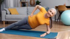 woman in side plank on a mat