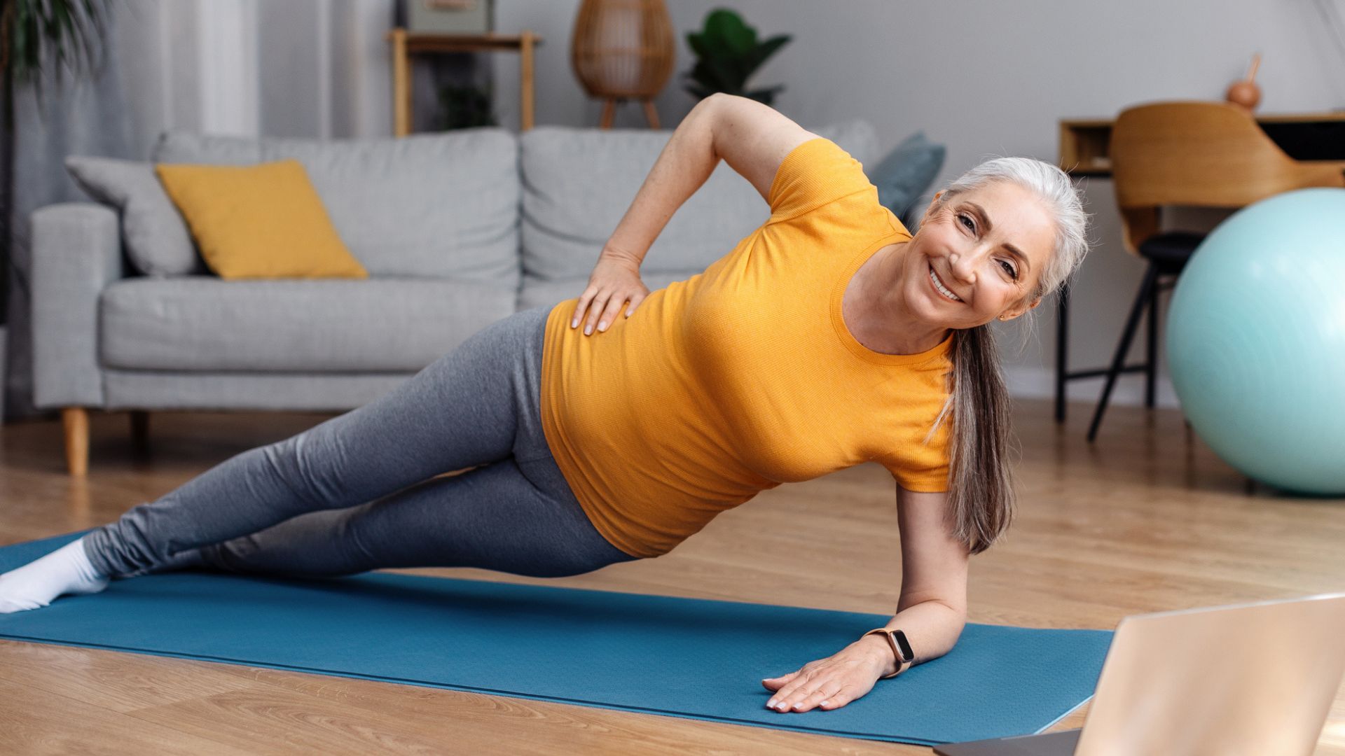 woman in side plank on a mat