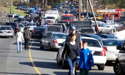 Parents pick up their children near Sandy Hook Elementary School in Newtown, Conn., after Friday's deadly shooting.