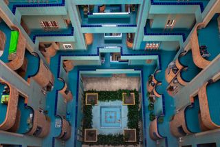 Photo from above of Walden 7, Barcelona, a large multistory residential building with blue tiled and brick balconies