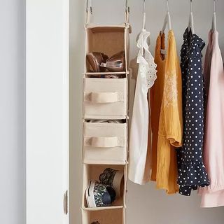 A fabric shoe organizer made from felt in a white closet