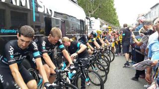 Team Sky warm up on the rollers before the start