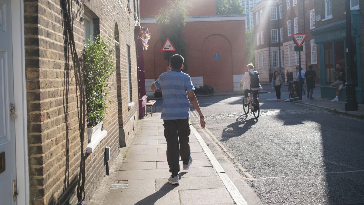 Fujifilm X100VI image gallery: person walking on urban London sidewalk with low lying sun