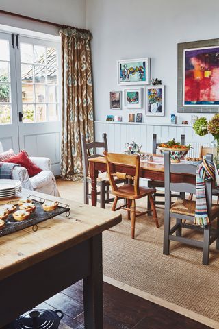 dining table and mismatched vintage chairs in open-plan country kitchen at christmas