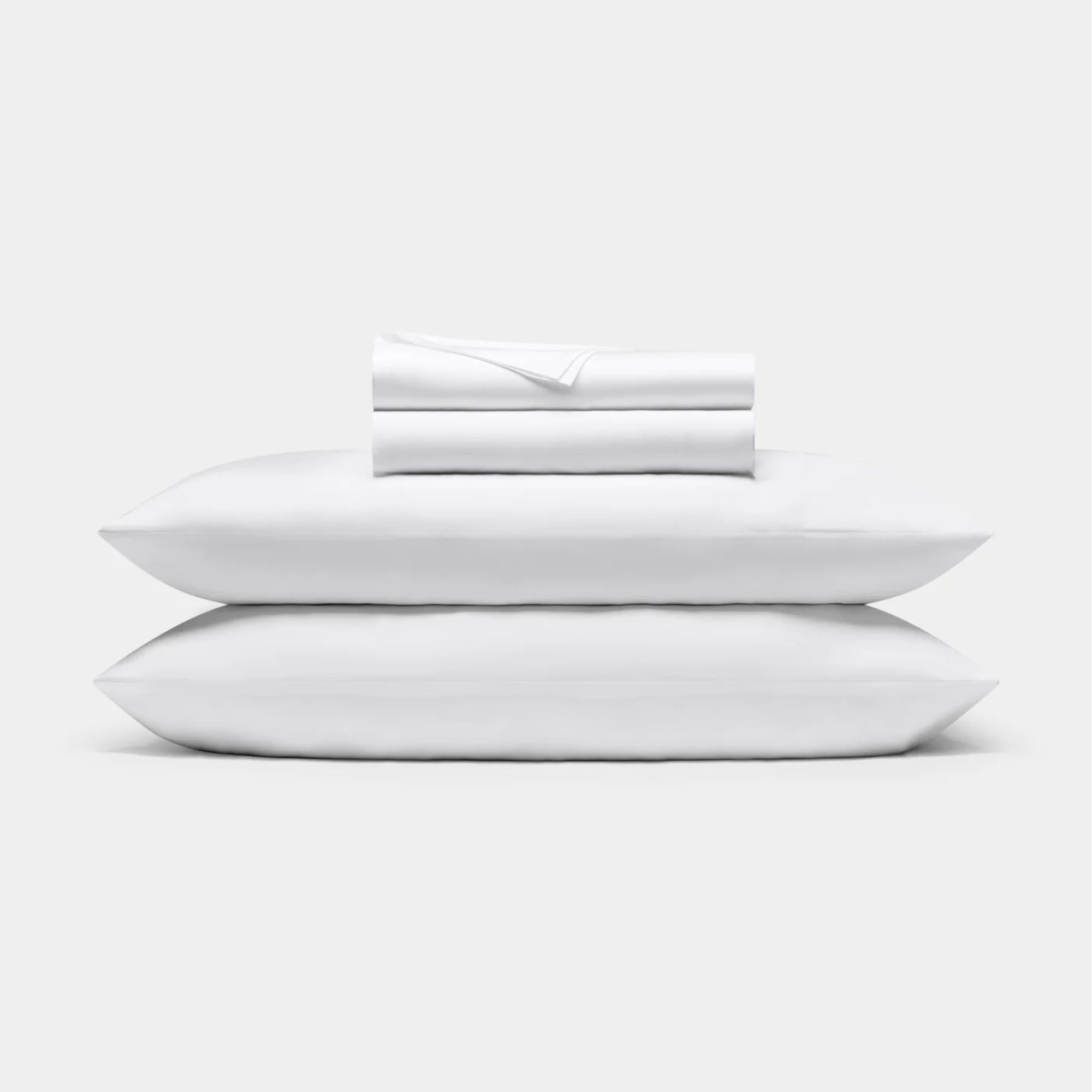 A stack of white Cozy Earth bamboo bed sheets