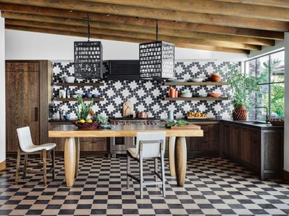 a kitchen with a checkerboard floor and monochrome tiles